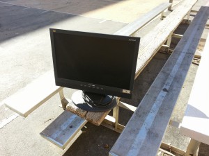 A monitor waiting to jump from a school bench into Robert's van